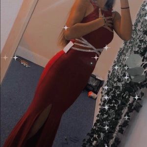 red prom dress never worn(around sparkles is see threw)tight fitting.Fits size 1